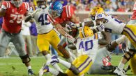 Jordan Wilkins breaks through the defense to gain yardage in the 40-24 loss to LSU on Saturday. Photo by Billy Schuerman